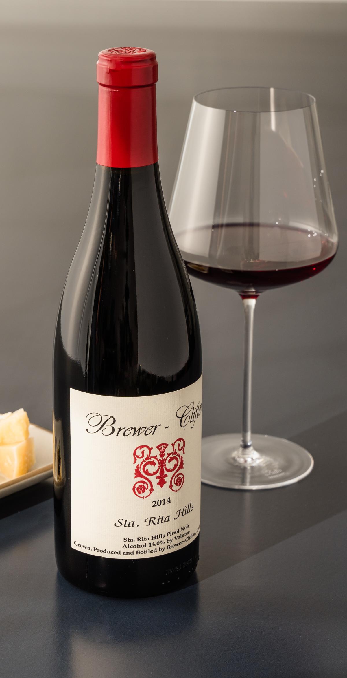 Pinot Noir red wine bottle, wine glass and cheese